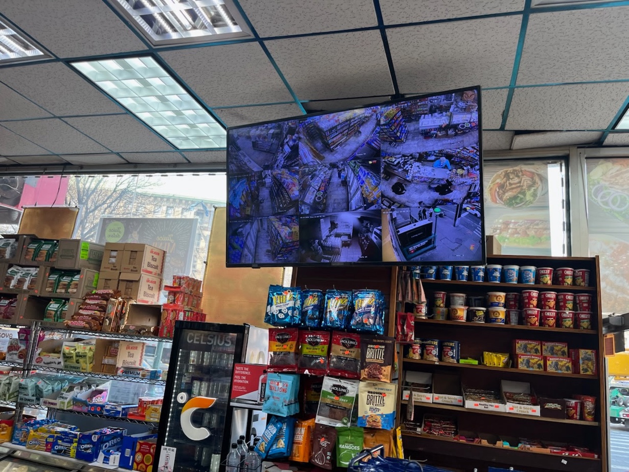 Security camera monitor displaying live feeds deli installation Washington Heights Manhattan NY